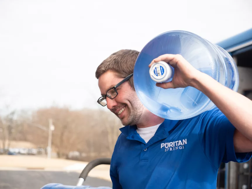 Puritan Springs employee delivering water to an office